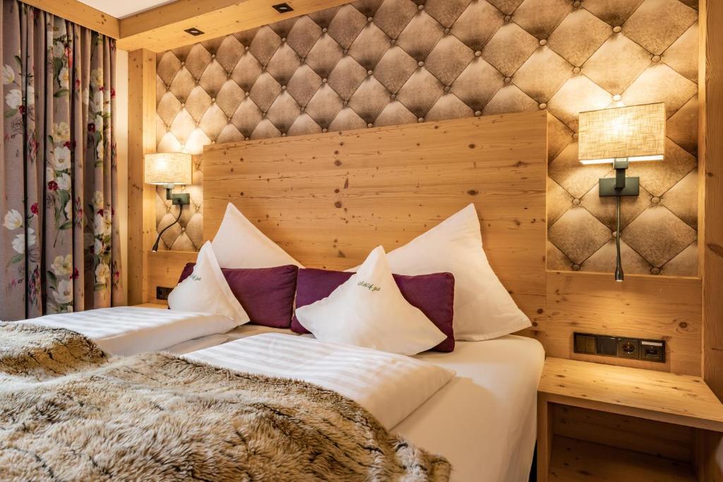 Postel nebo postele na pokoji v ubytování Hotel Pramstraller