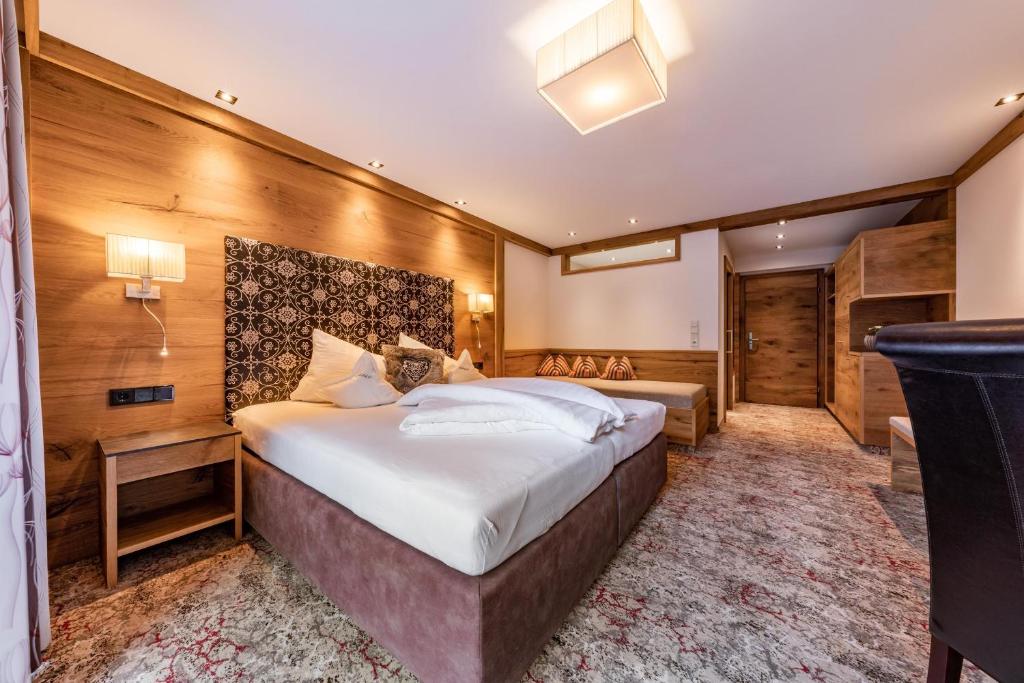 Postel nebo postele na pokoji v ubytování Hotel Pramstraller