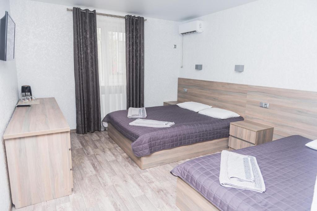 Postel nebo postele na pokoji v ubytování Hotel Voyage Вояж