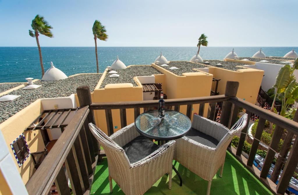 a balcony with a table and chairs and the ocean at Altamar 53 balcony sea views By CanariasGetaway in Playa del Aguila