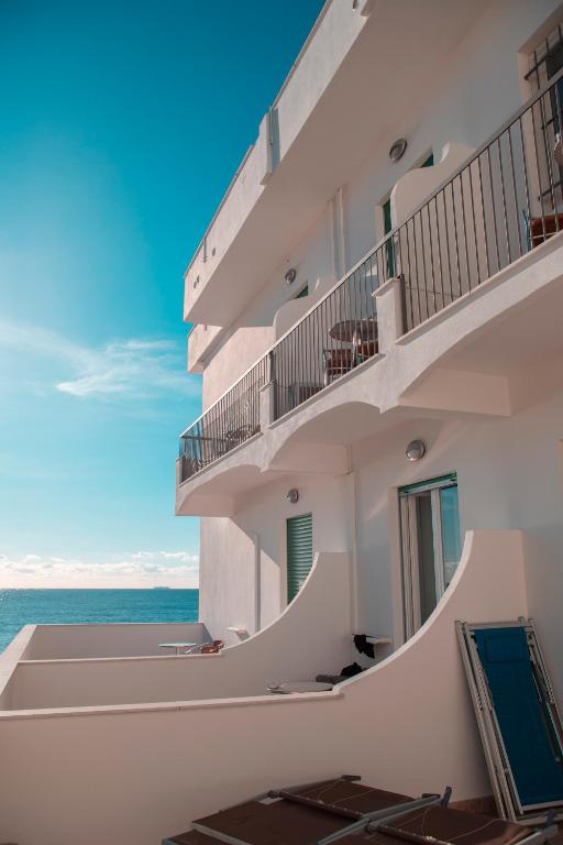 a white building with a view of the ocean at Hotel Ligure in Spotorno