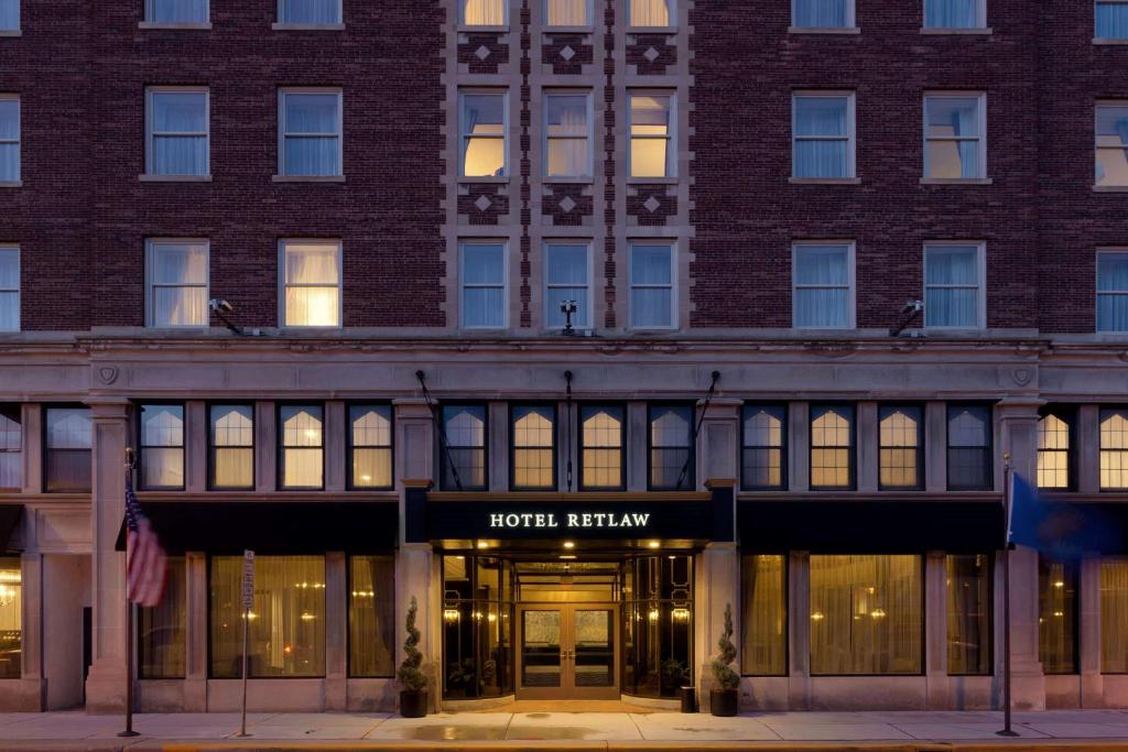 a large brick building with a hotel exterior at Hotel Retlaw, Trademark Collection by Wyndham in Fond du Lac