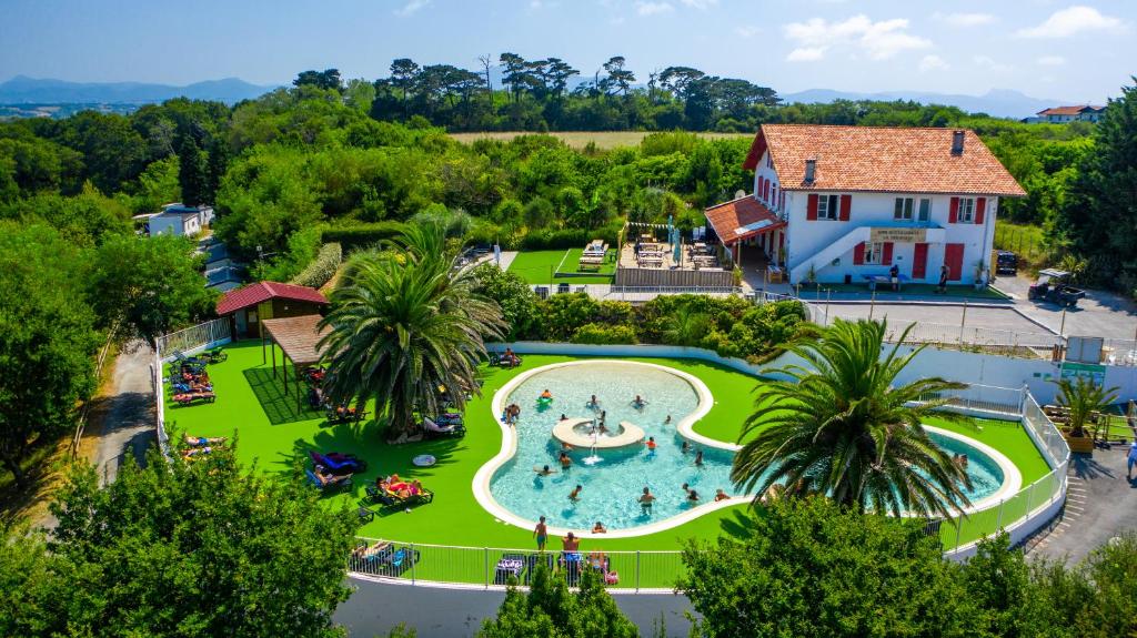 an overhead view of a large swimming pool in a park at Camping Erreka in Bidart