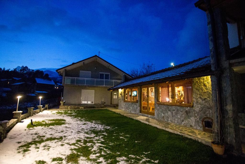 a house with a lawn in front of it at night at Kuća za odmor Gloria in Travnik
