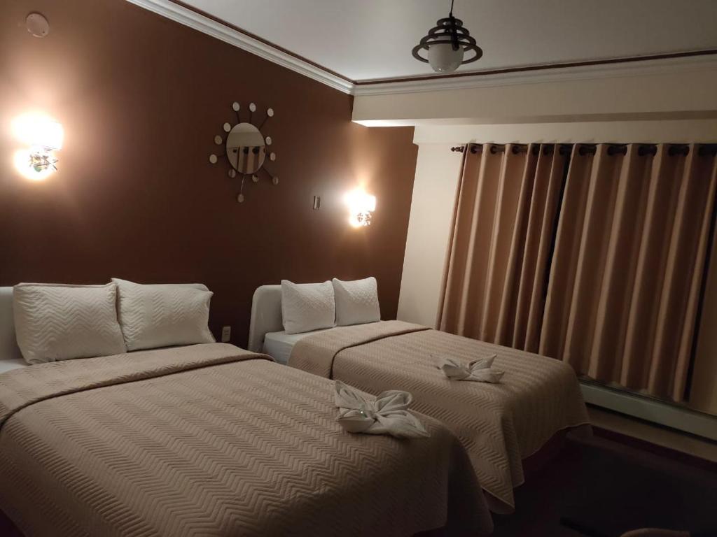 A bed or beds in a room at Hotel Espectacular