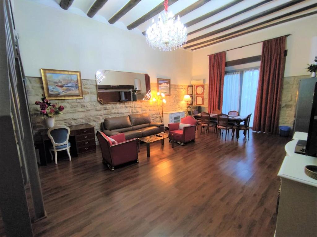 a living room with a couch and chairs and a table at Luz del Renacimiento Ubeda in Úbeda