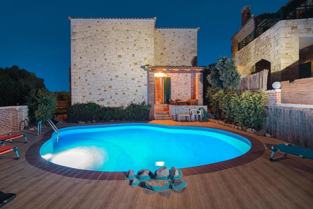 a swimming pool in the backyard of a house at Neriides Villas in Hersonissos