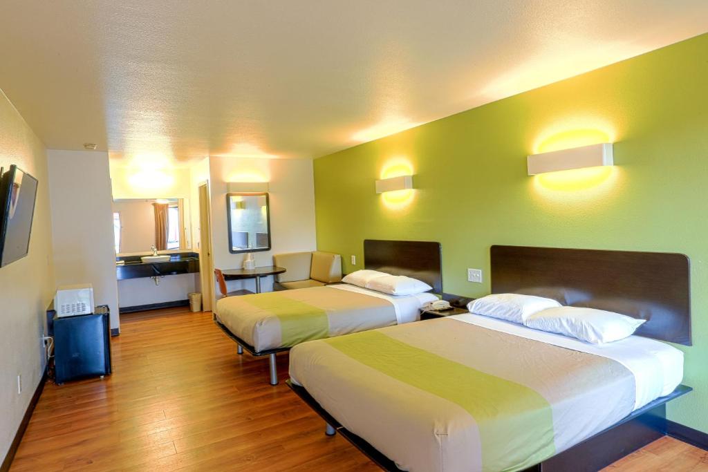 a hotel room with two beds and a kitchen at Motel 6-Longview, TX - North in Longview
