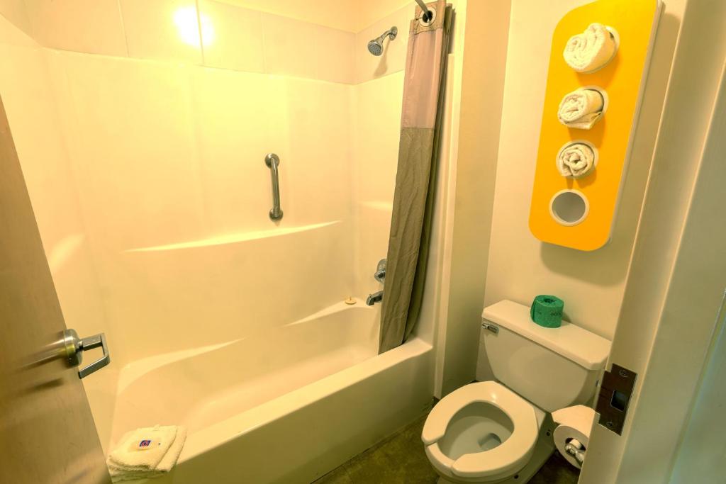 a bathroom with a white toilet and a shower at Motel 6-Longview, TX - North in Longview