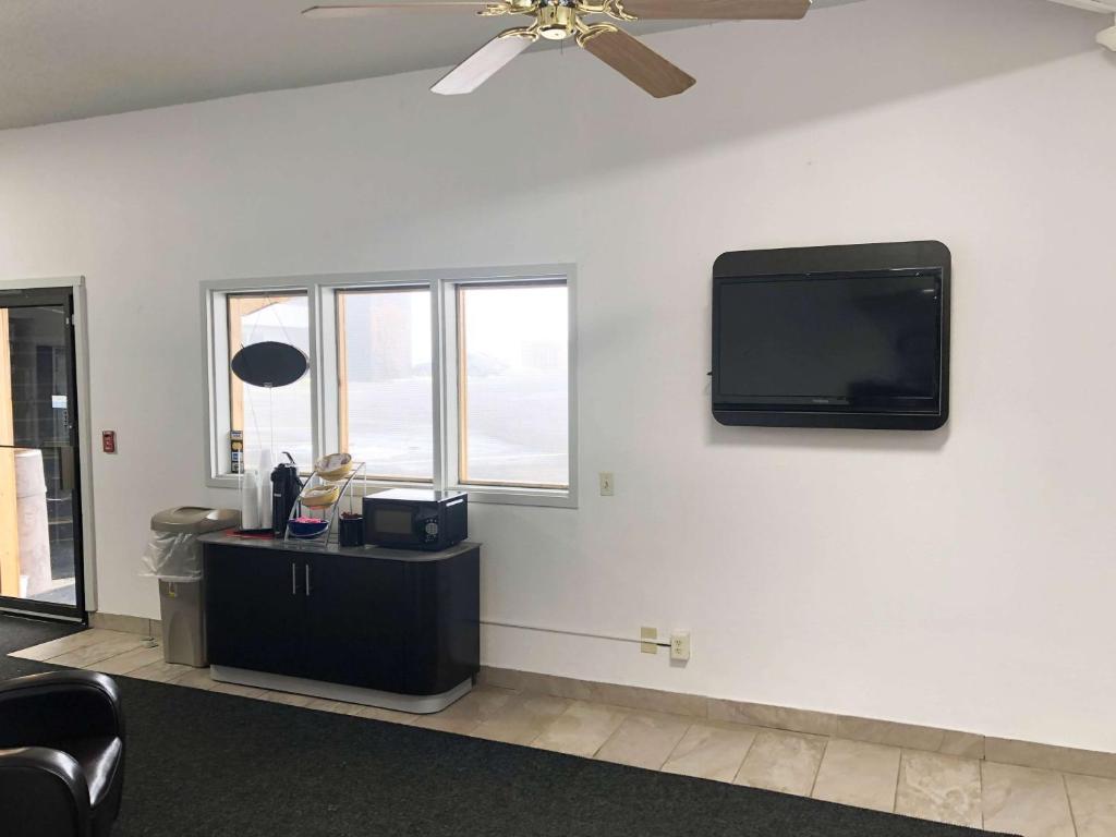 a living room with a flat screen tv on a wall at Motel 6 Missoula, Mt - Wye - Travel Plaza in Missoula