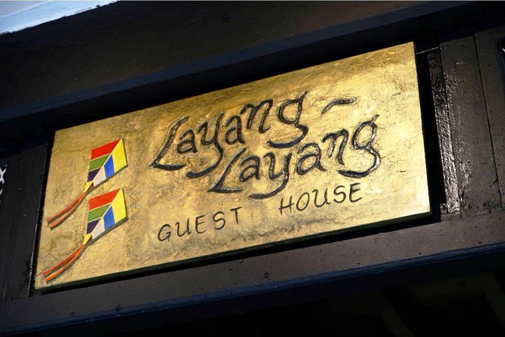 a sign for a kite laaza guest house at Layang Layang Guest House Melaka in Malacca