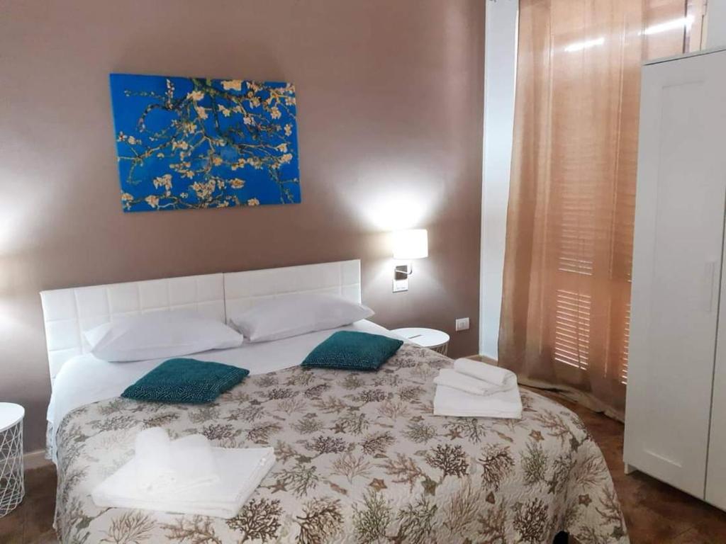 Postel nebo postele na pokoji v ubytování Le Suite dei Due Mari cucinino privato