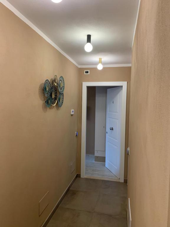 a hallway with a door and a clock on the wall at Locanda il Deserto in Livorno