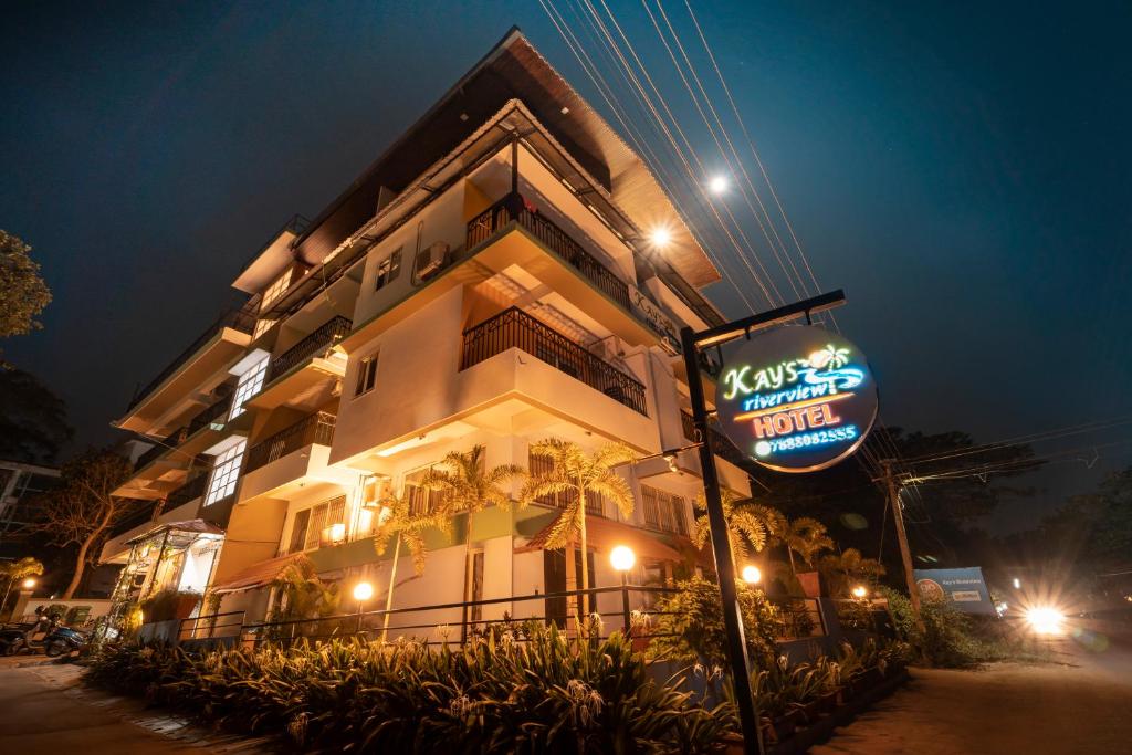 un cartello di un hotel di fronte a un edificio di notte di Kay's Riverview Resort a Baga