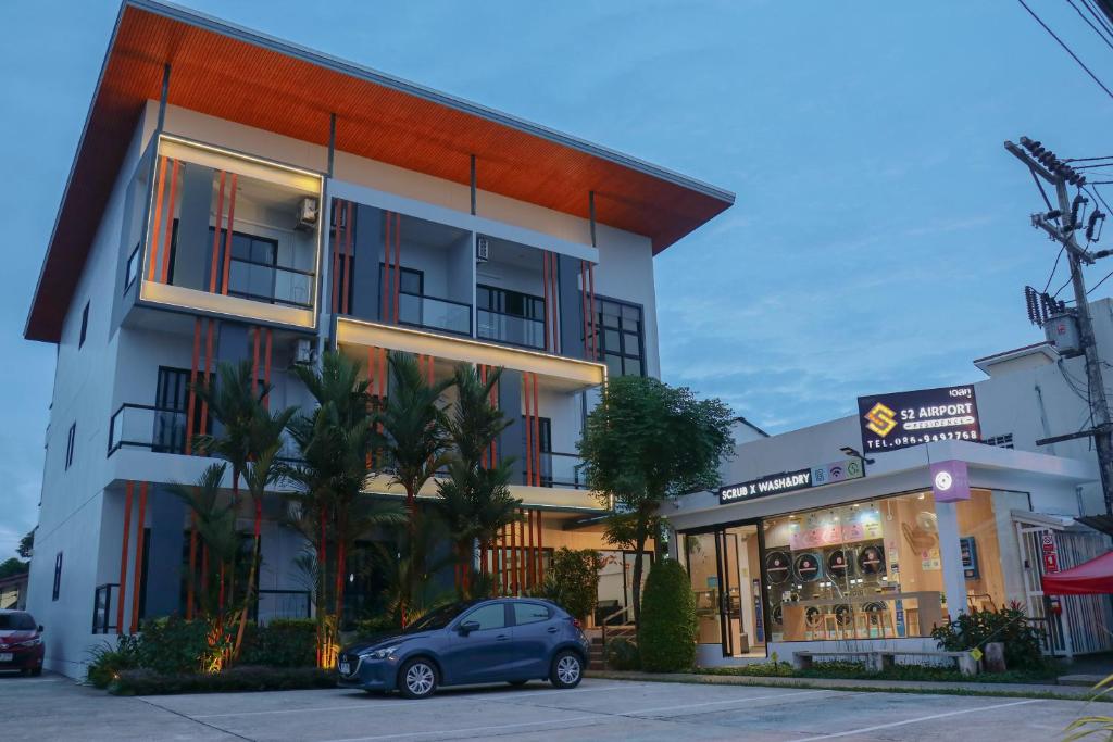 a car parked in front of a building at S2 Airport Residence in Nai Yang Beach