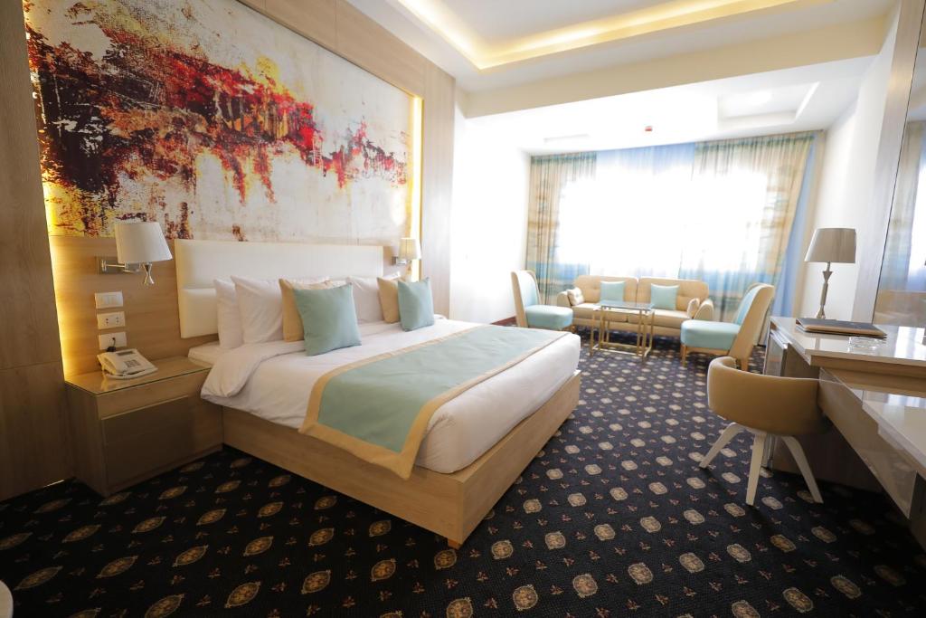 Postel nebo postele na pokoji v ubytování Tolip Gardens Hotel