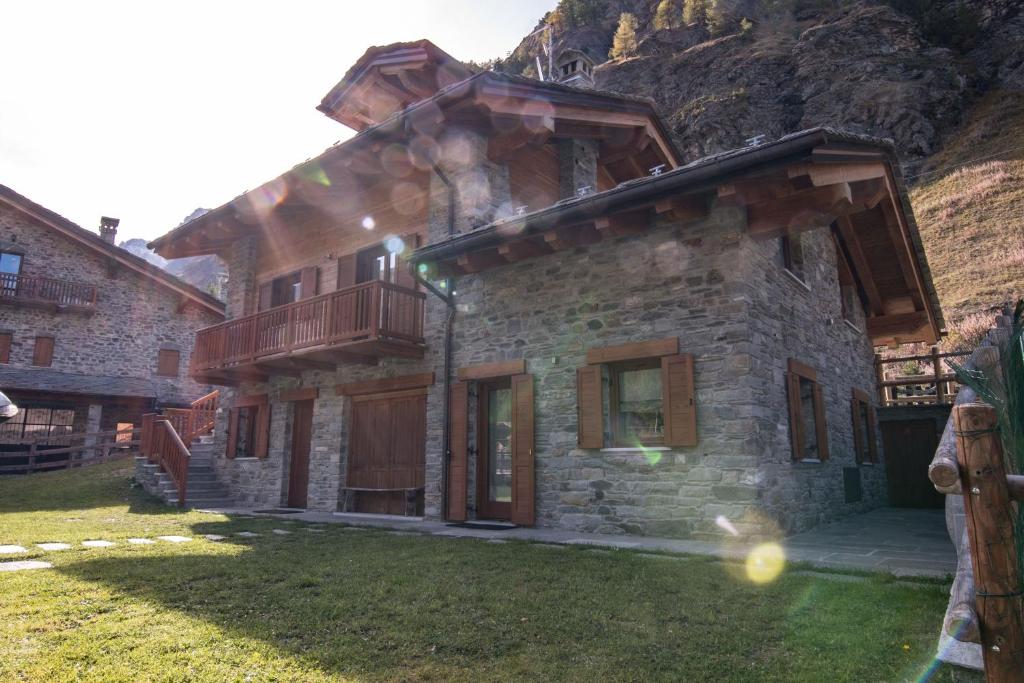 a stone house with a balcony on top of it at Chalet Mountain Relax - CIR 0001 in Rhêmes-Notre-Dame