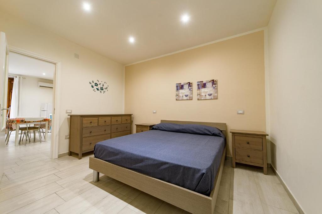 a bedroom with a blue bed and a dining room at Naranji House Blue - Relax in Altavilla Milicia