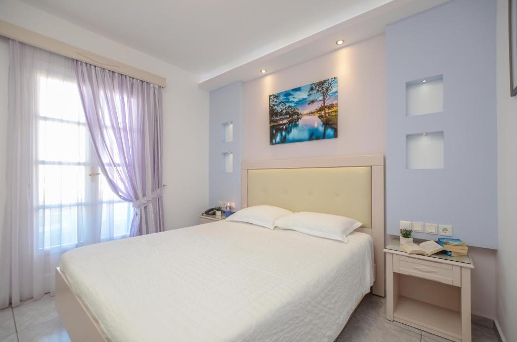 Postel nebo postele na pokoji v ubytování Ilion Hotel