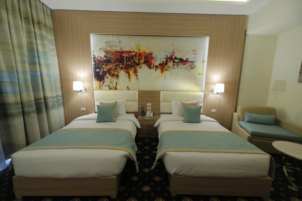 Postel nebo postele na pokoji v ubytování Tolip Gardens Hotel