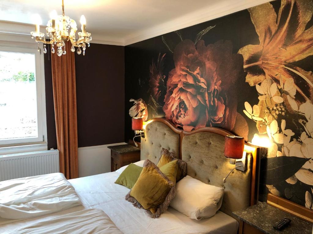 a bedroom with a bed with a large painting on the wall at Corso, Bed & Breakfast & Cafe in Pressbaum