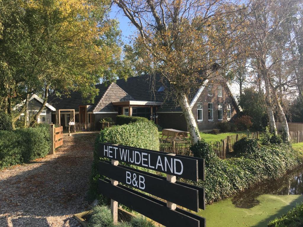 a sign in front of a house with a yard at Het Wijdeland in Zwolle