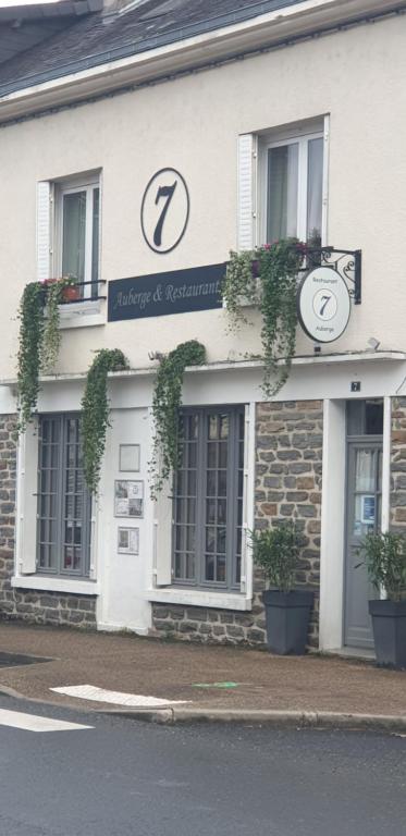 a building with two clocks on the front of it at le 7 pompadour in Pompadour