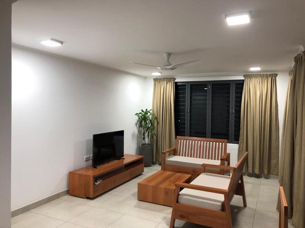 a living room with a couch and a television at Kolibri Holiday Apartments in Victoria