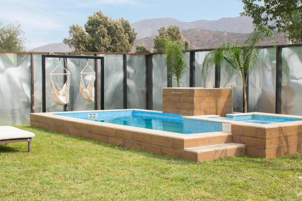 a large swimming pool in a yard with at La Finca de Vane in Valle de Guadalupe