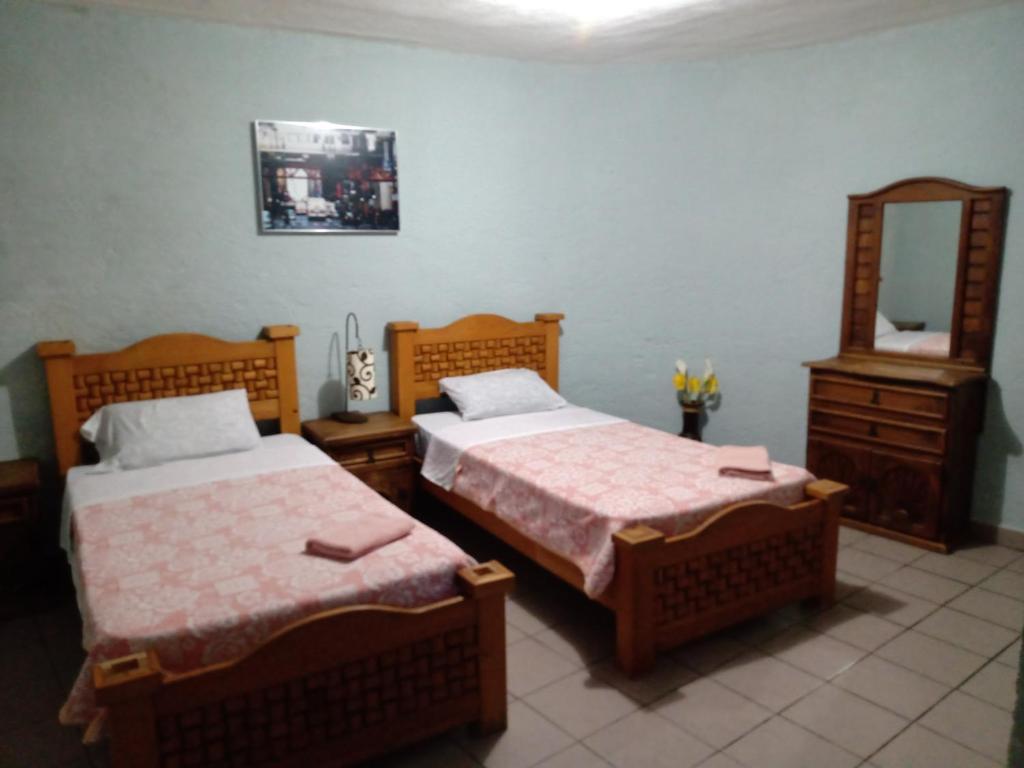 Postel nebo postele na pokoji v ubytování Hospedaje San Antonio Tepoztlán.