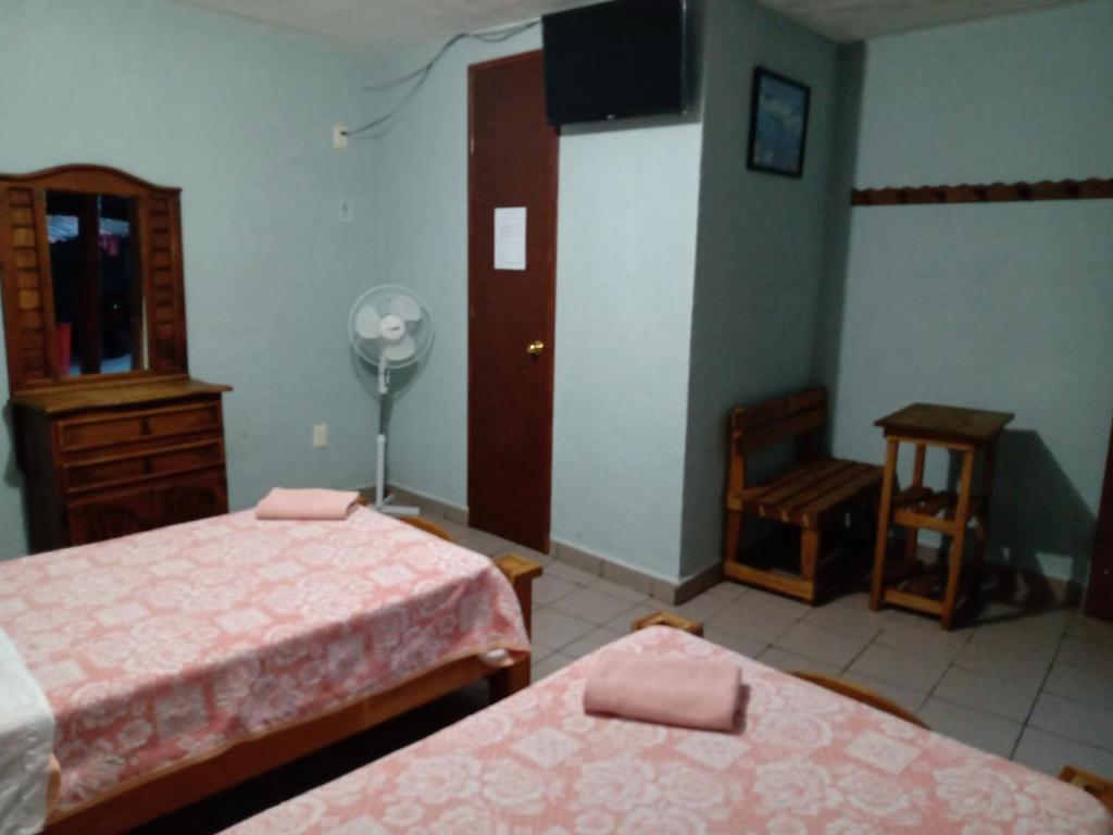 Postel nebo postele na pokoji v ubytování Hospedaje San Antonio Tepoztlán.