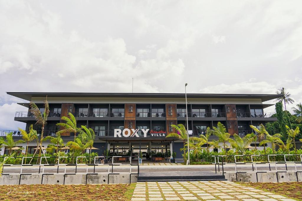 a building with a rory hotel in front of it at Roxy Sematan & Telok Serabang in Sematan