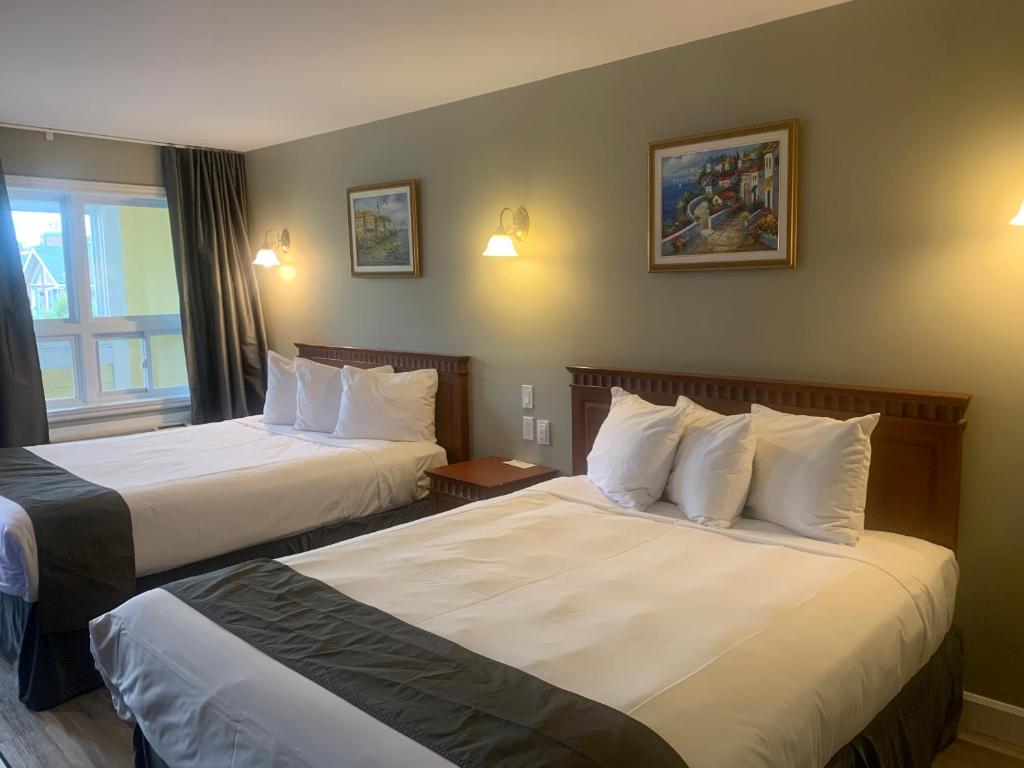 Una cama o camas en una habitación de Hotel and Suites Les Laurentides
