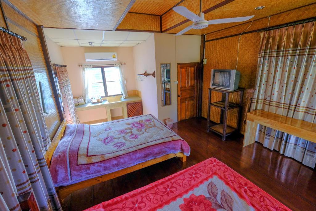 Postel nebo postele na pokoji v ubytování Pai Tewdoi ปาย ทิวดอย รีสอร์ท