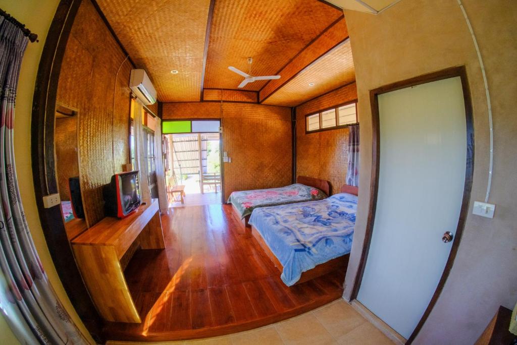Postel nebo postele na pokoji v ubytování Pai Tewdoi ปาย ทิวดอย รีสอร์ท