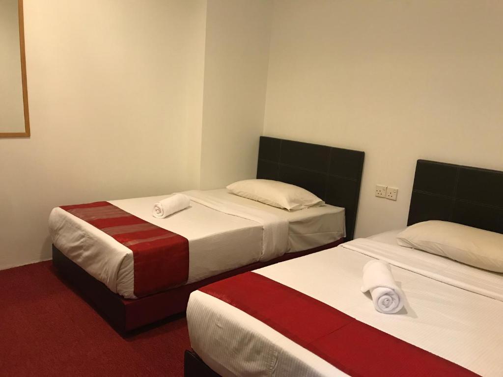 Postel nebo postele na pokoji v ubytování HL HOTEL Kota Bharu