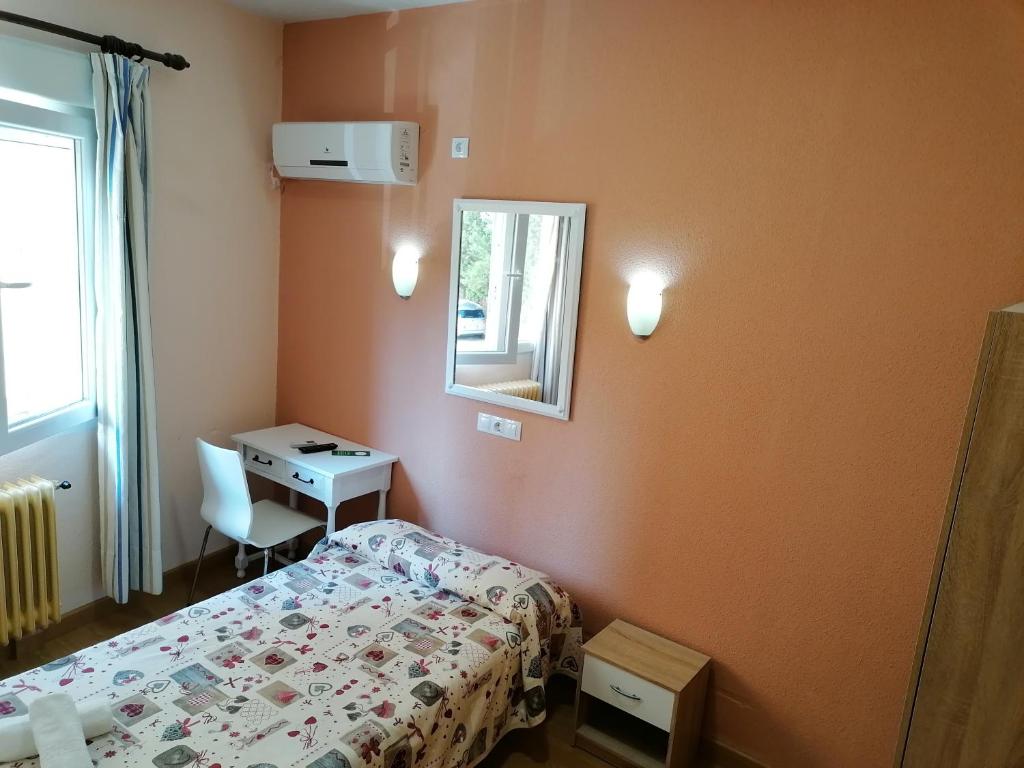 A bed or beds in a room at Hostal Hernan Cortes