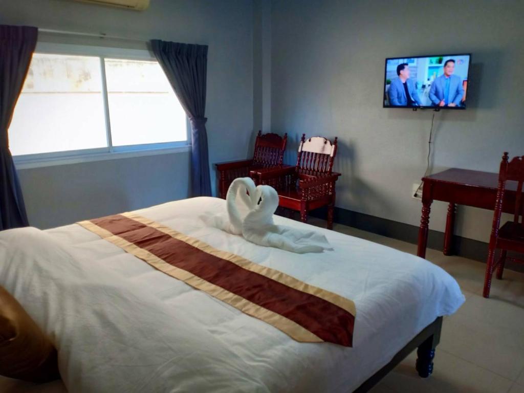 Postel nebo postele na pokoji v ubytování Submukda Phoomplace Hotel