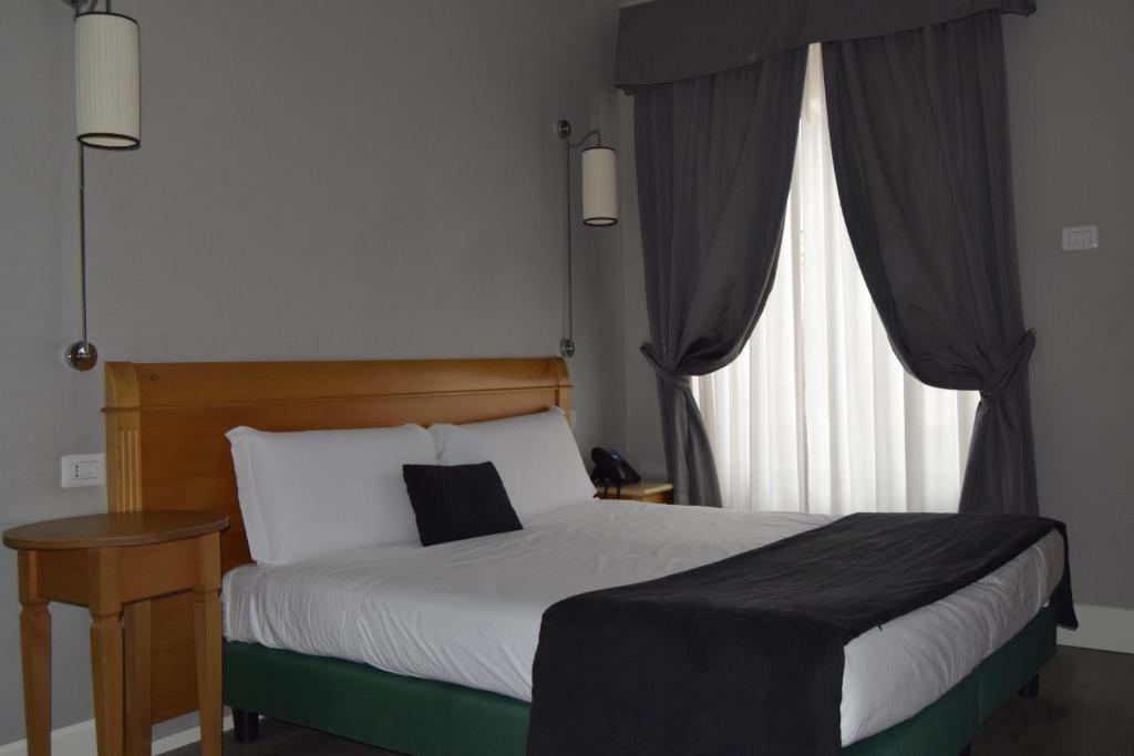 Postel nebo postele na pokoji v ubytování Hotel dei Quiriti