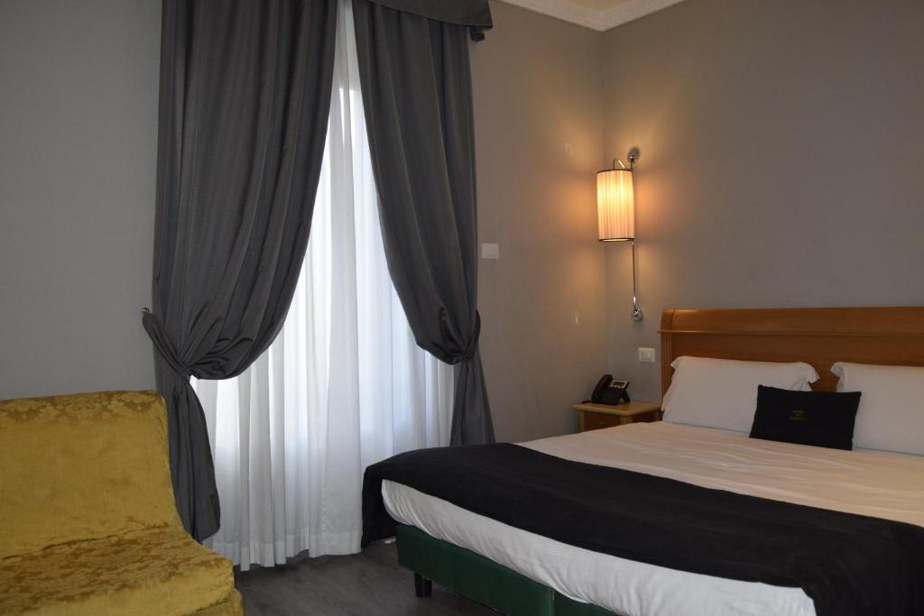 Postel nebo postele na pokoji v ubytování Hotel dei Quiriti