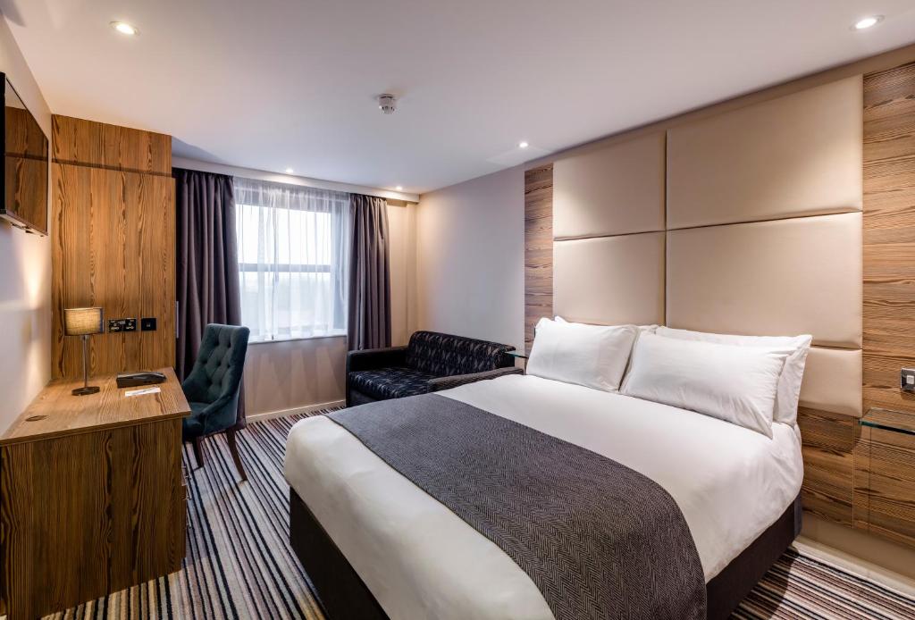 a bedroom with a large bed and a large window at Holiday Inn York City Centre, an IHG Hotel in York