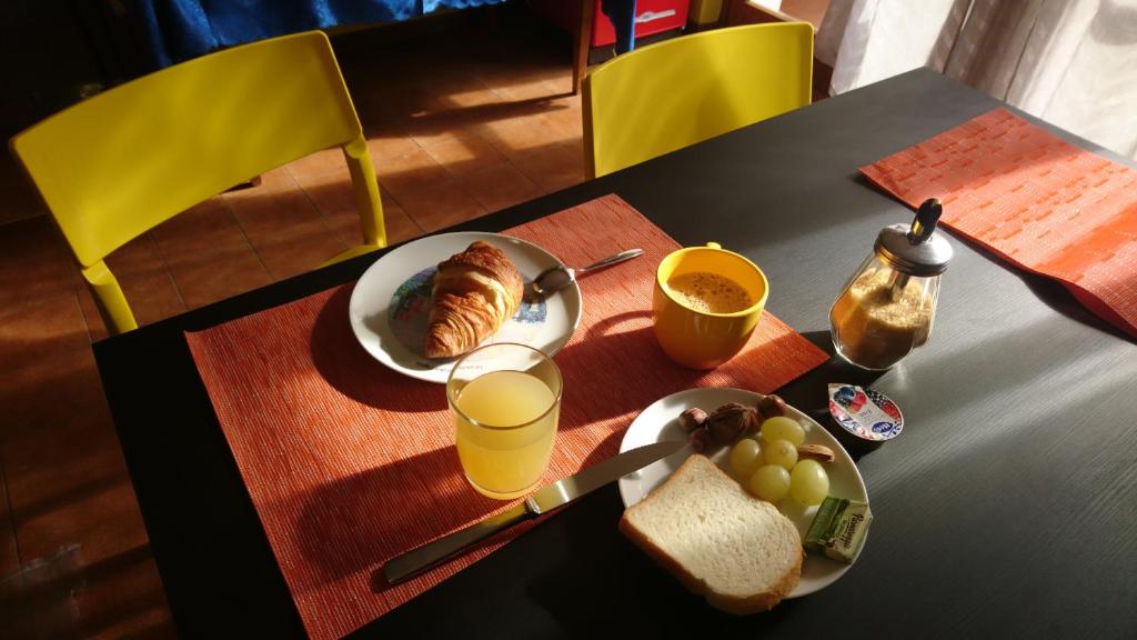 a table with a plate of food and drinks on it at B&B La Moka Verona in Verona