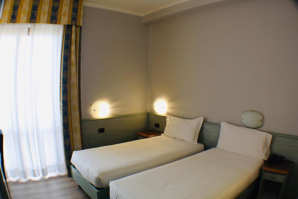 Postel nebo postele na pokoji v ubytování Hotel Europa Milano