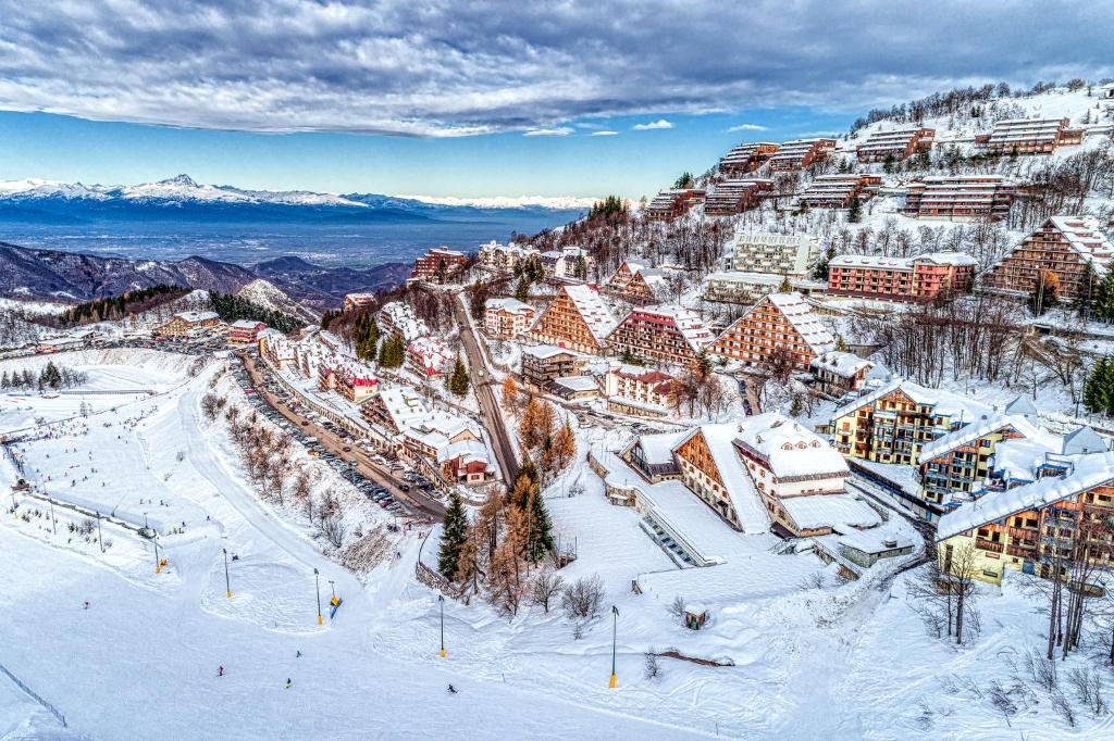 an aerial view of a resort in the snow at Hotel Mondolé in Prato Nevoso