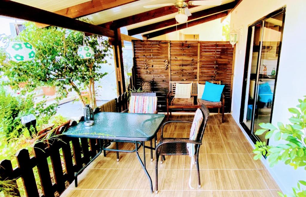 a patio with a green table and chairs at Maria's Place in Polis Chrysochous