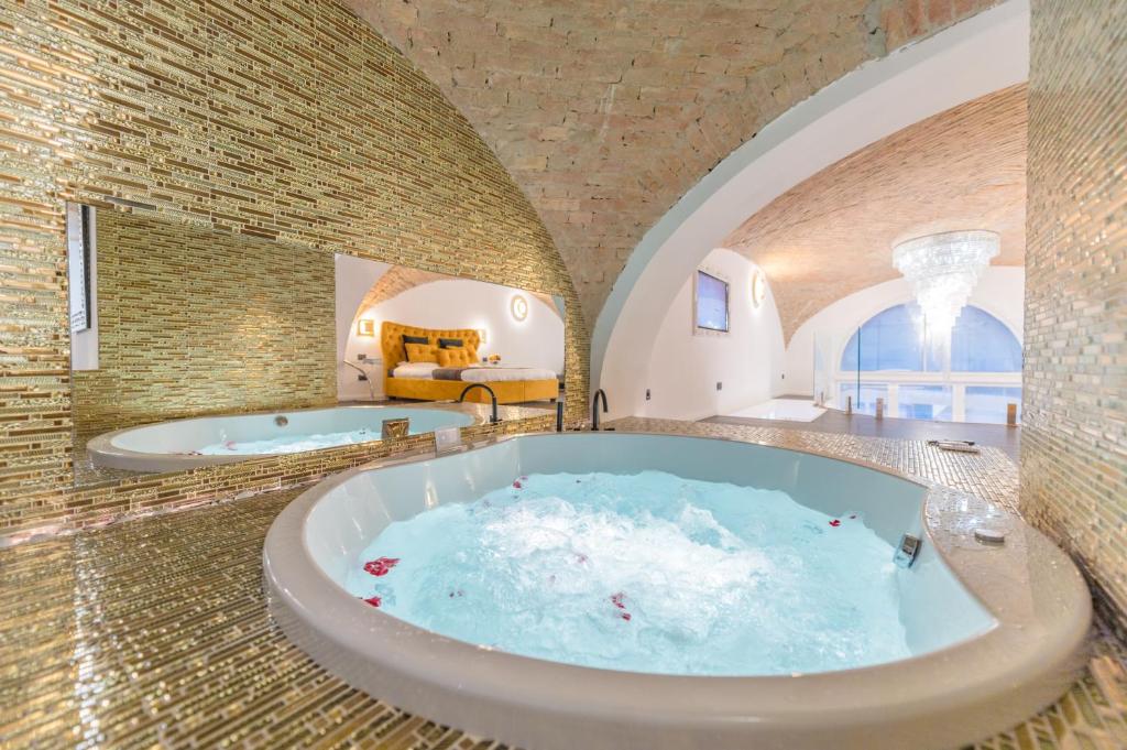 a large bathroom with two jacuzzi tub at Budapest Presidential in Budapest