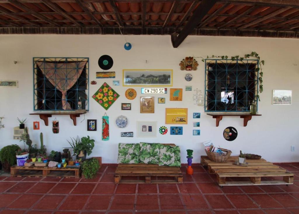 a living room with couches and pictures on the wall at Hostel 35 in Canoa Quebrada