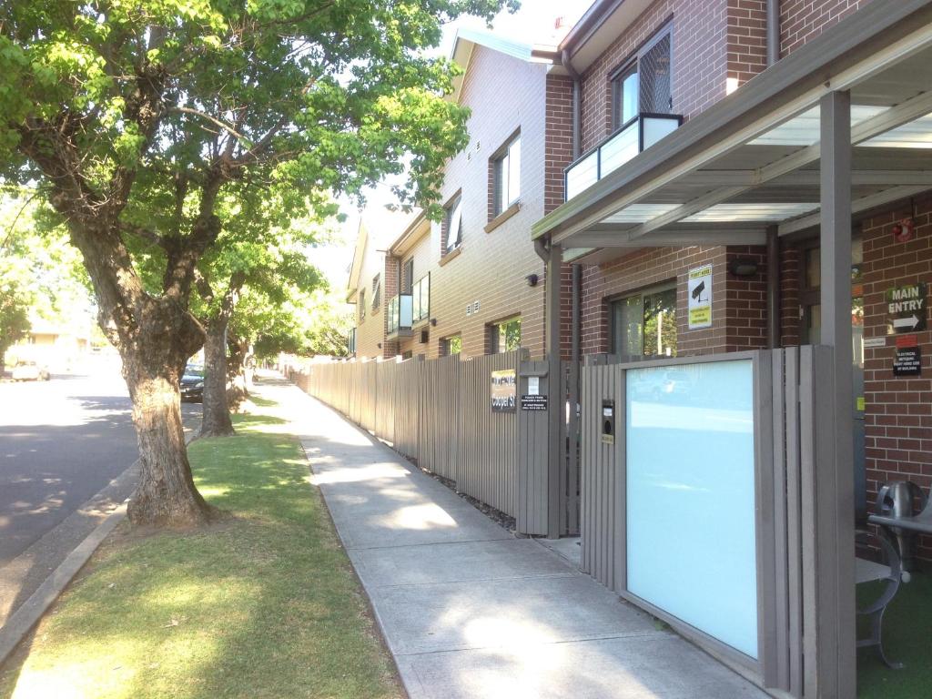 a building with a door on the side of a sidewalk at Strathfield Executive Accommodation in Sydney