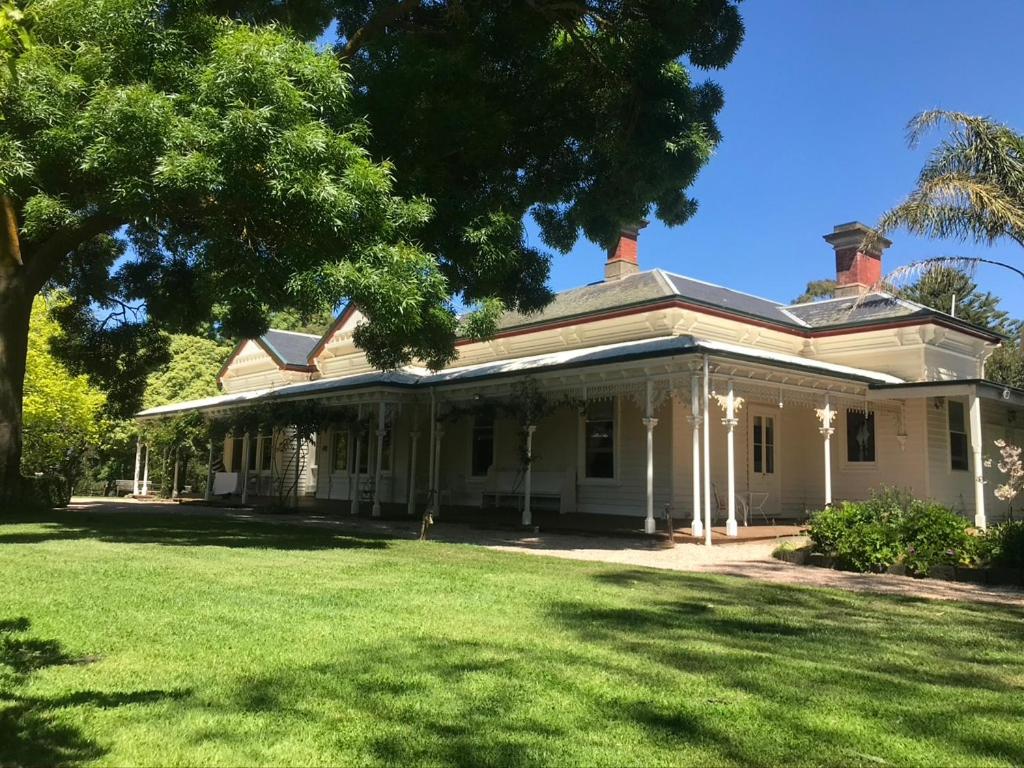 an old white house with a large yard at Quamby Homestead in Woolsthorpe
