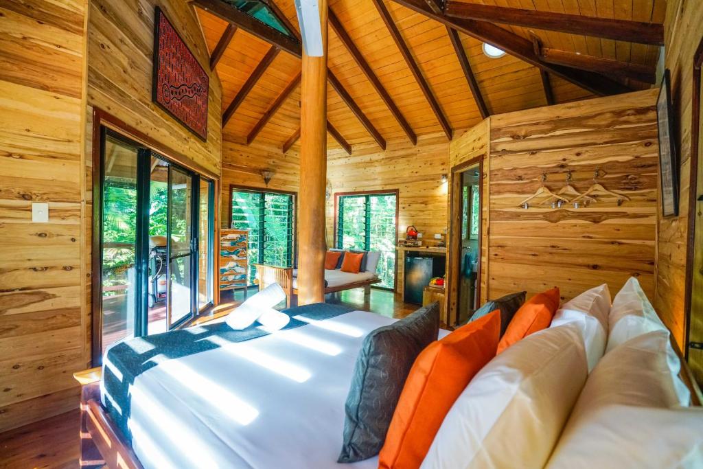 Wildwood في كيب تريبيوليشن: غرفة نوم مع سرير كبير في كابينة خشب